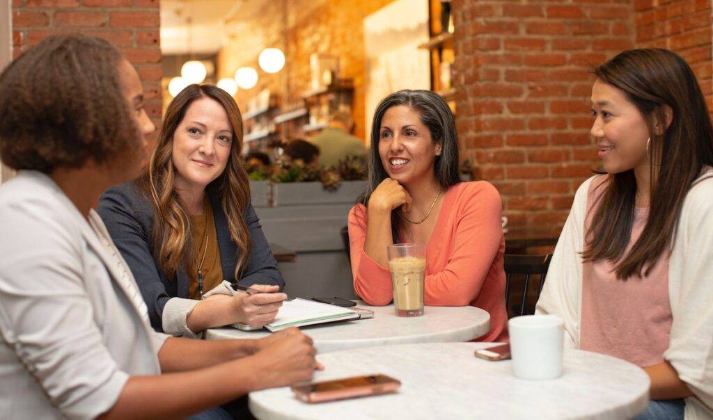 four job seekers discussing how to write a CV/resume